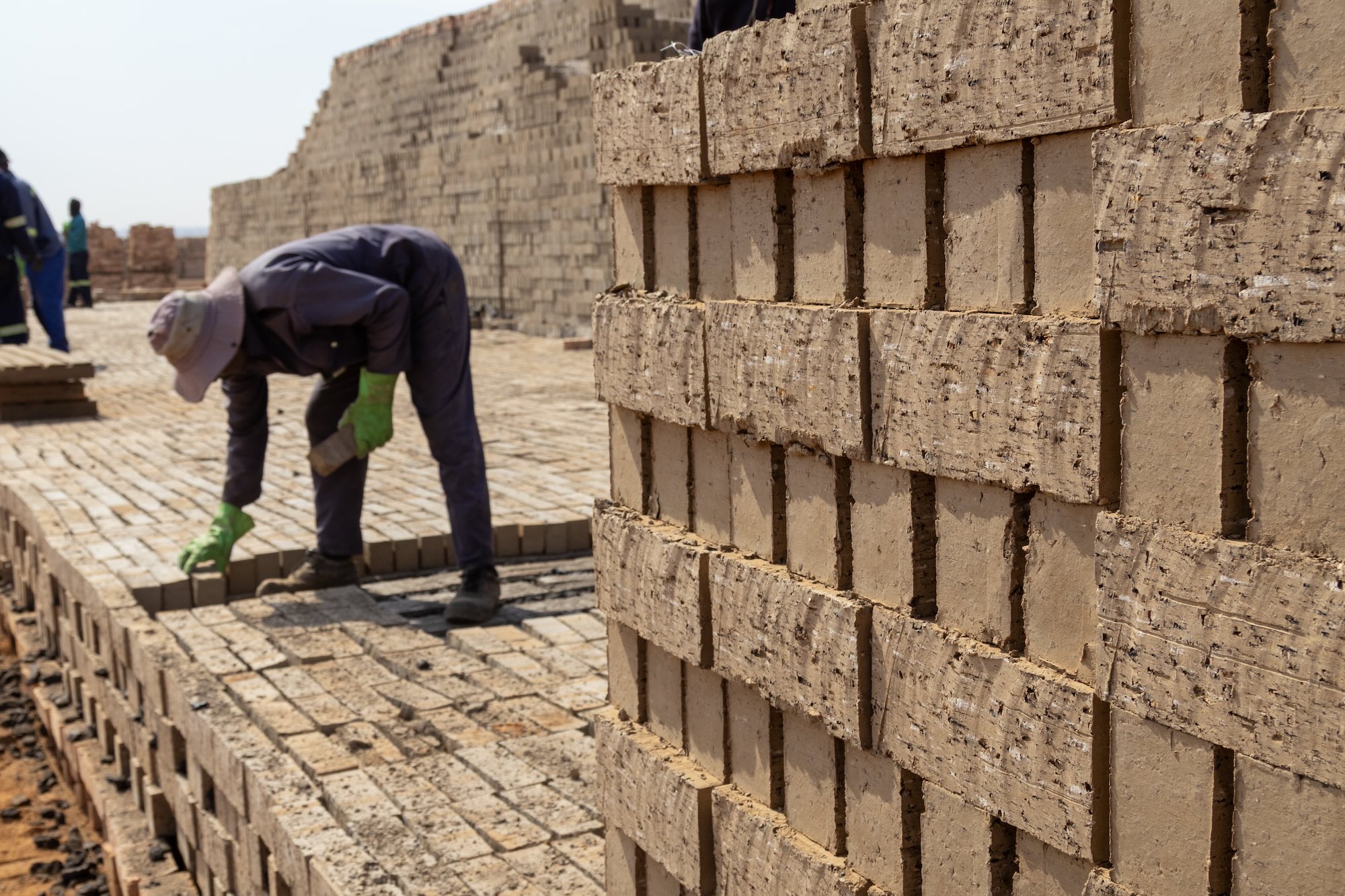 Bending down to place a brick