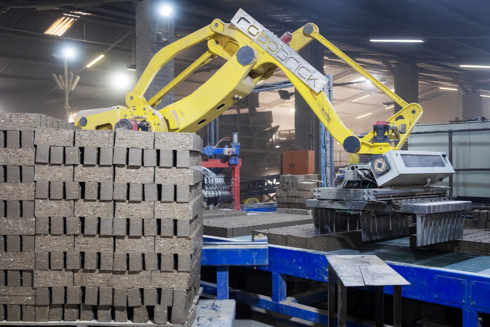 Bricks with yellow robotic Hand